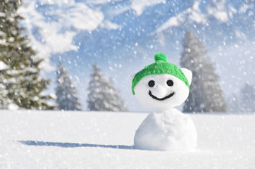 Funny snowman against Swiss Alps