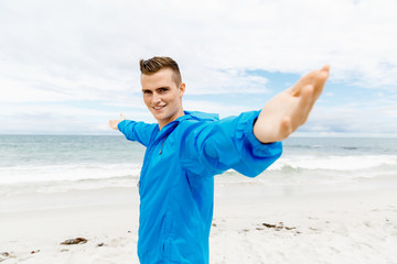 Young man in sport wear with outstretched arms