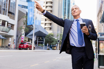 Businessman catching taxi in city