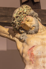 Banska Stiavnica - The detail of carved statue of Christ on the cross 