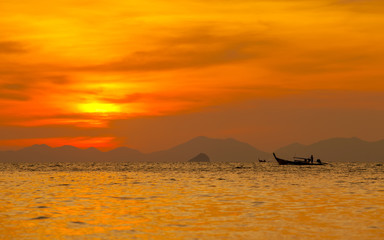 Fototapeta na wymiar Silhouetted of boat in the sea at Krabi, Thailand.