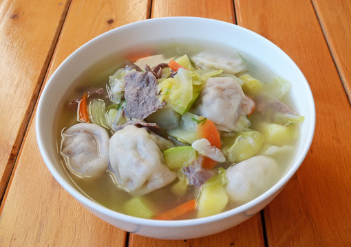 Soup with dumplings, vegetables and meat slices