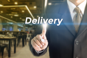 A Businessman holding a white sign with the message Delivery. Can bring to the medium of your ad.