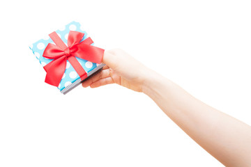 gift box with red ribbon in hand on white background