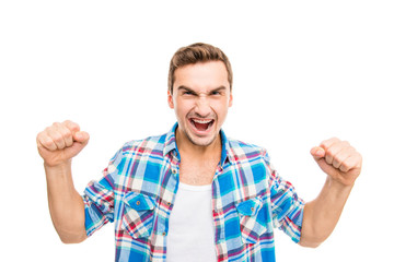 Young furious man shouting and showing fists