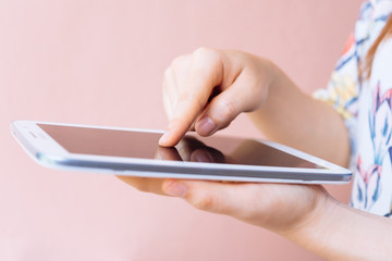 woman hands browsing a tablet and touching screen with finger
