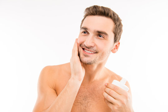 Handsome Man Holding Lotion After Shave Smearing Cheek