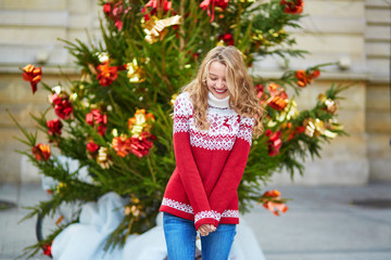 Girl with a brightly decorated Christmas tree