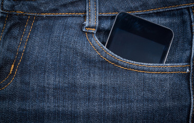 Black smartphone in your pocket jeans. background.