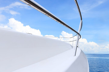 blue sky above white yacht on water