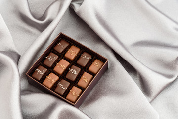 Special occasion box of salted caramel chocolates on a silver background
