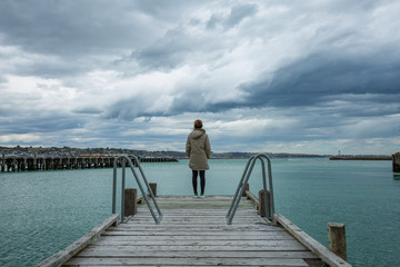 woman stand at the edge of the bridge