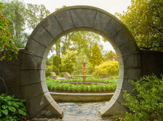 Stone archway in the garden - 98483643
