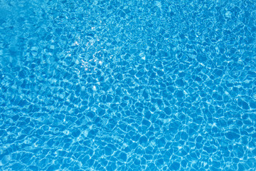 Fototapeta na wymiar Blue and bright water surface in swimming pool