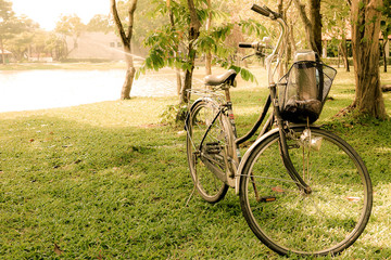 Fototapeta premium Yellow vintage tone a bicycle in the garden