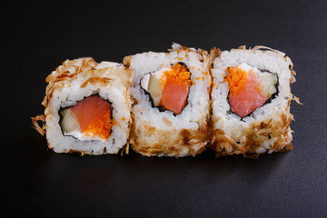 fresh sushi roll with smoked salmon, on black backgorund