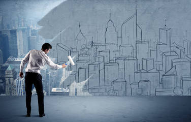 Elegant salesman repainting the city on wall