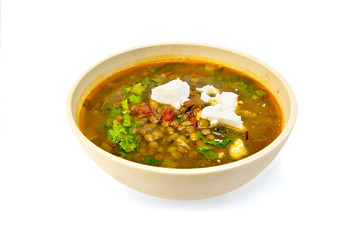 Soup lentil with spinach and cheese in yellow bowl