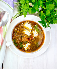 Soup lentil with spinach and cheese on board top