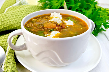 Soup lentil with spinach and feta on board
