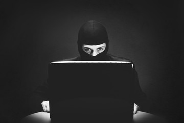 Hacker stealing computer data at night