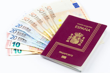 Spanish passport with european union currency banknotes on a white background
