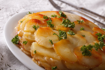 Anna potatoes with butter on a plate macro. horizontal
