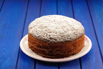 Homemade chocolate fruit christmas cake on blue table