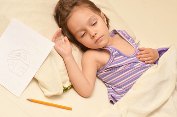 Little girl sleeping with picture