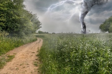 Danger storm producing a Tornado over green field