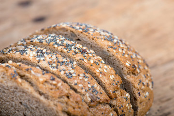 Rustic bread and wheat on an old vintage planked wooden table