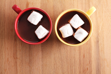 chocolate drink and marshmallows in colorful cups