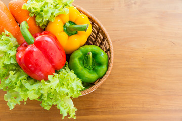 Healthy vegetable in basket put on wooden table