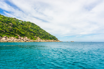 Naklejka premium Rocky island with Turquoise Water and Green Palm Trees
