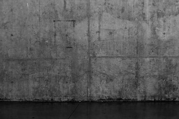 Grungy dark concrete wall and wet floor