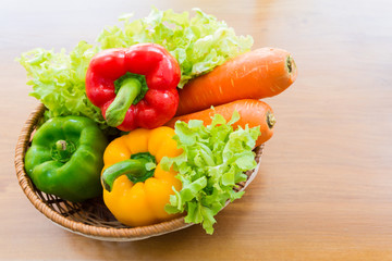 Healthy vegetable in basket put on wooden table