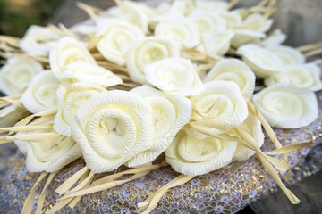 White artifical flowers (used during a funeral) - kind of wood flower to be placed on the site of cremation in Thailand.