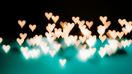 beautiful bokeh of lights on defocused background in a form of hearts