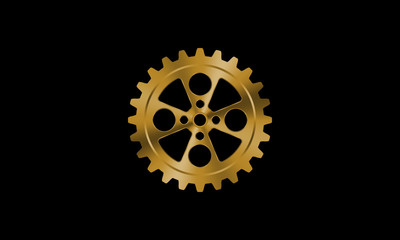 Golden gear on black background.
