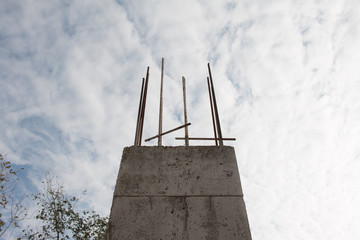 Reinforced steel bars on construction pillars, concrete details and beams at building site.