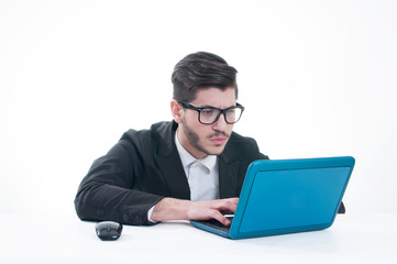 Young business man looking at his laptop with disappointment