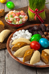 Novruz in Azerbaijan. Colored eggs for Easter and traditional sweets. Selective focus.