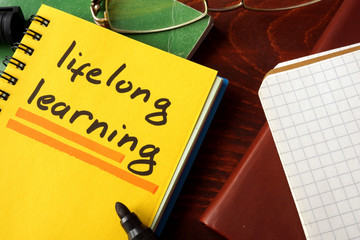 Notebook with  lifelong learning sign. Education concept.