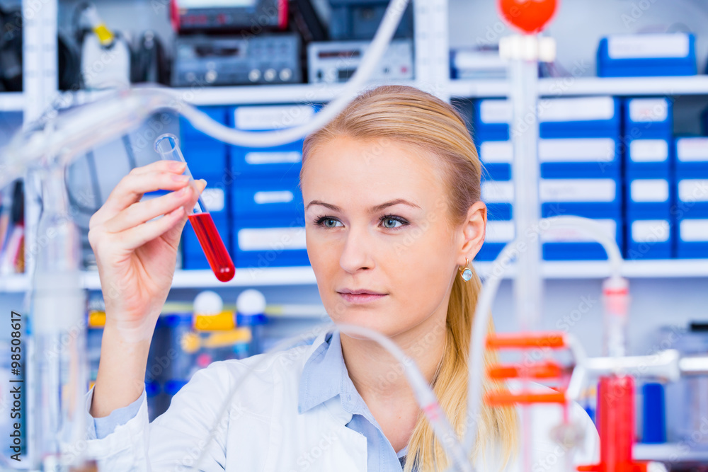 Poster Chemical laboratory scene: attractive young student scientist ob