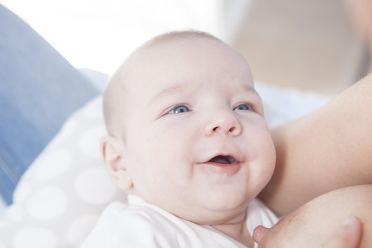Smiling baby while he is breastfed