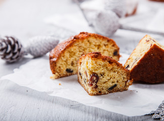 Traditional Christmas Fruit Cake in a sugar glaze  with marzipan and cranberry decor on a Christmas decoration background.selective focus.