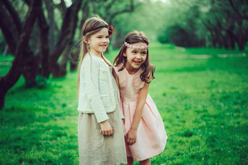 two happy kid girl playing together in summer, outdoor activities, friendship concept