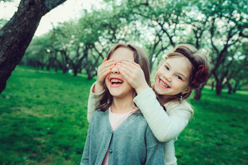 two happy kid girl playing together in summer, outdoor activities, friendship concept