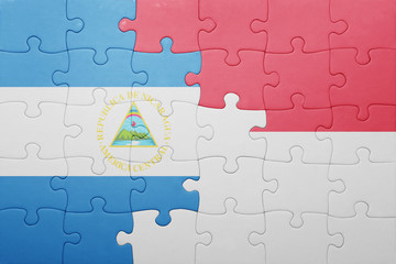 Fototapeta premium puzzle with the national flag of indonesia and nicaragua