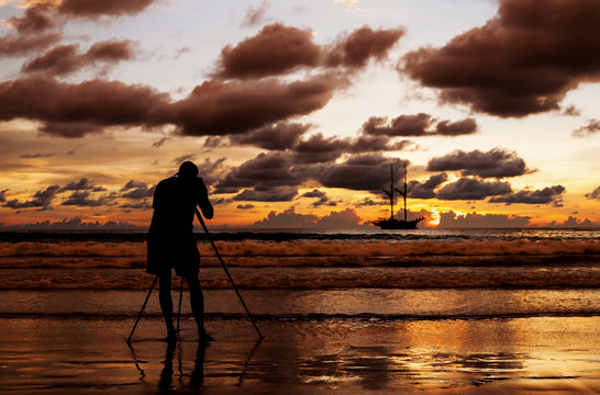 Silhouette photographer shooting image on the beach